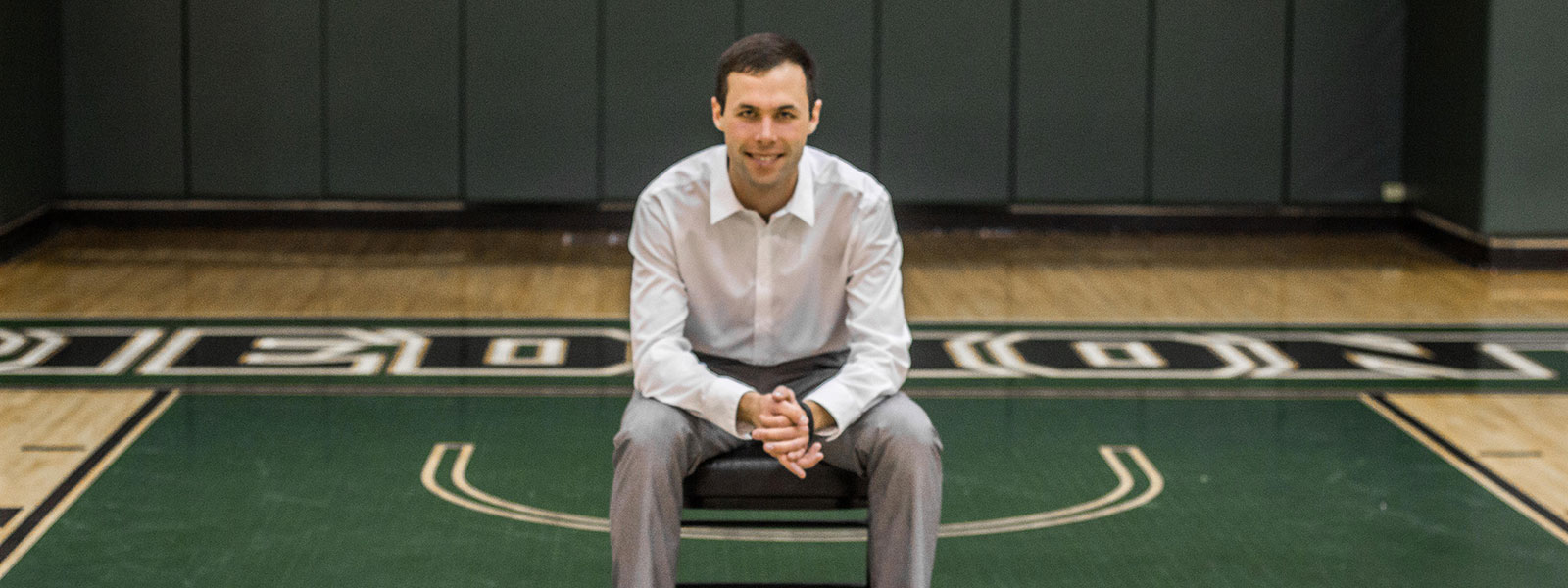 jake sitting on piedmont college's basketball court