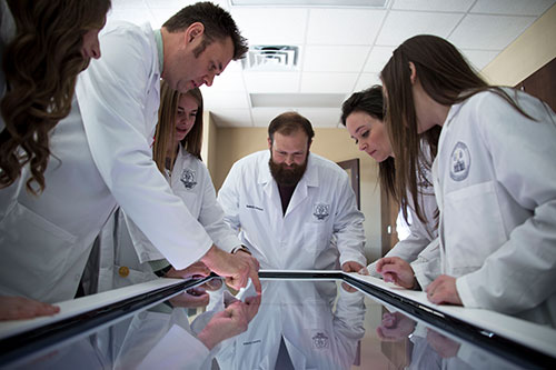 Biology students and faculty around anatomage table