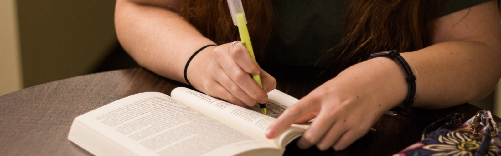 Student highlighting in book